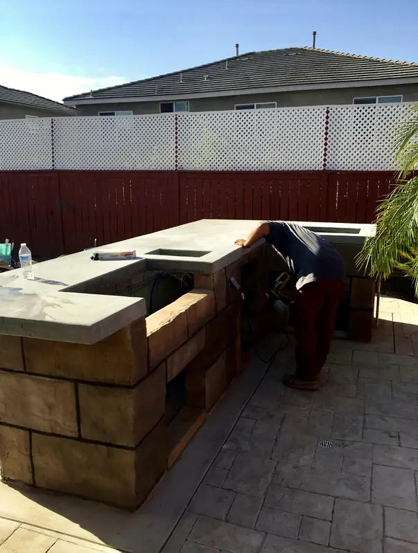 An outdoor kitchen island being built in cast block