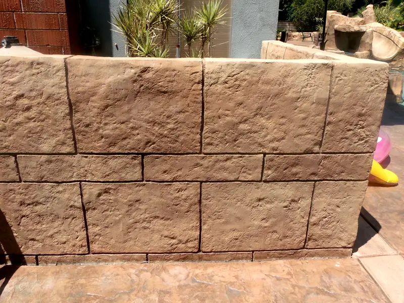 Hand-carved concrete wall with a cut-stone texture
