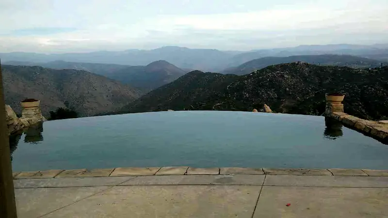 Infinity-edge pool looking out over layered mountain ridges