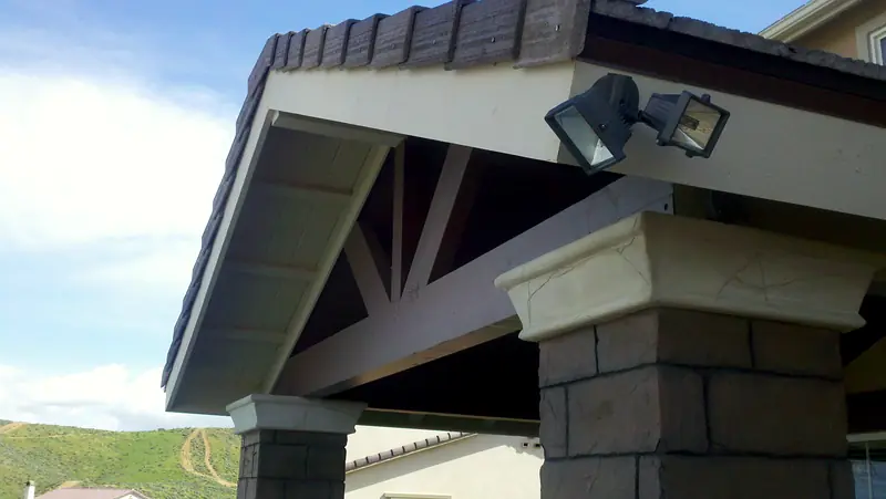 Patio cover with recessed lighting and a stone-clad column