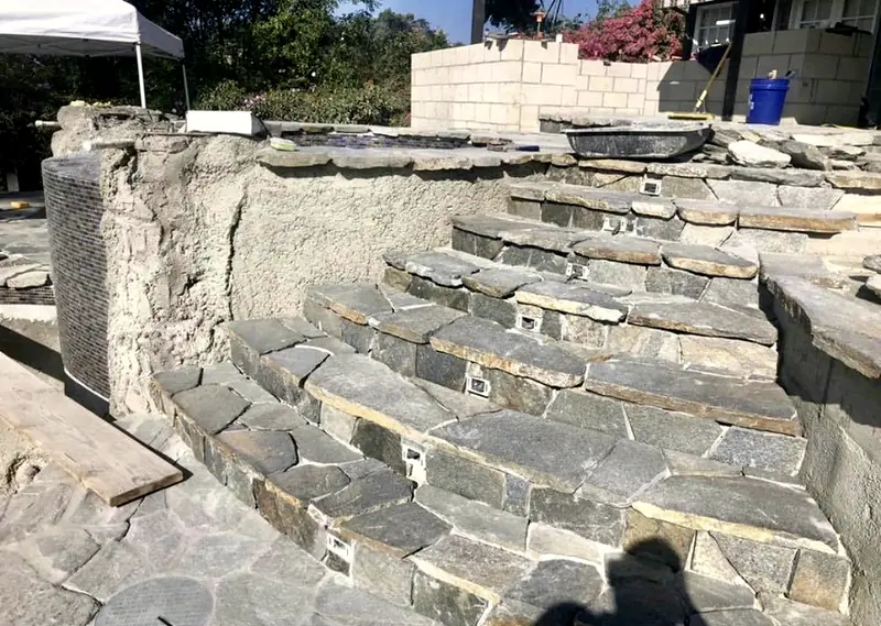 Curved flagstone stairs with step lights wired in