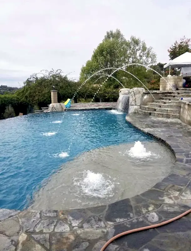 Deck jets and bubblers on the shallow shelf of the finished pool