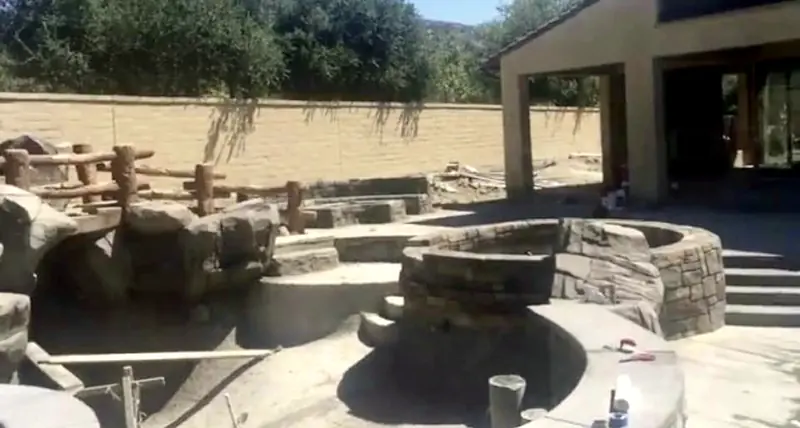 A sculpted rock waterfall taking shape before the water goes in